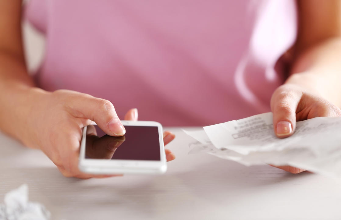 a woman sitting at a table using a laptop: Do you have to log into your bank account every payday to settle all of your monthly bills? Why? Get your payments to leave your account automatically and free yourself of this time-wasting task.