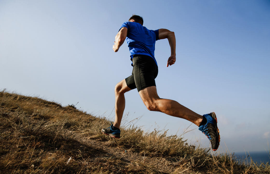 a man jumping in the air: Whether you’re a walker or a runner, adding hills to your workout will increase your stamina and leg strength—and up the sweat factor! Depending on where you live, you might enjoy the added challenge of trail running, which involves much more up and down than running on city streets, plus more fresh air and beautiful scenery than you’ll find on a treadmill at the gym.